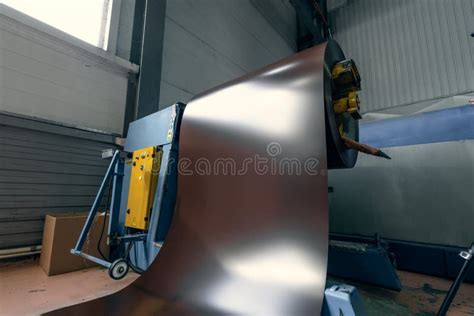 Roll Of Galvanized Steel Sheet At Cutting Machine And Metalforming