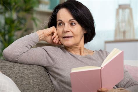 Senior Woman Reading Book At Home Photo Background And Picture For Free