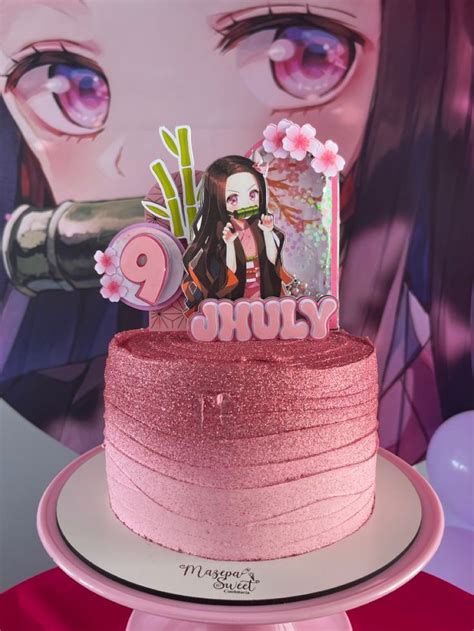 A Pink Cake Sitting On Top Of A Table Next To A Wall With An Anime