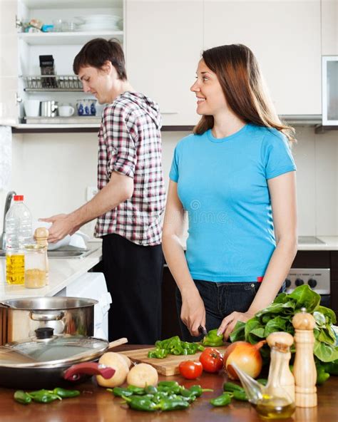 Woman Cooking Food While Man Washing Dishes Stock Photo Image 41892425