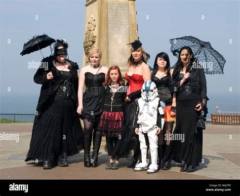 A Group Of Women And Children Dressed As Goths Pose In Front Of James