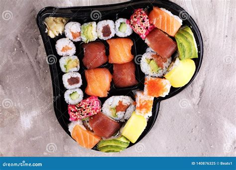 Close Up Of Sashimi Sushi Set With Chopsticks And Soy Sushi Roll With