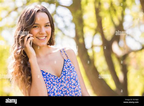 Pretty Brunette Having Phone Call In The Park Stock Photo Alamy