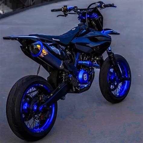 A Black And Blue Motorcycle Parked On The Street