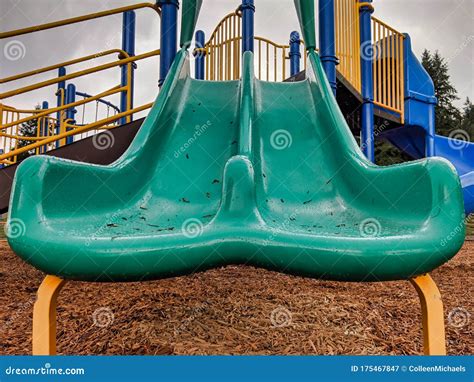 Low Angle View Of A Colorful Playground Slide After A Rainy Day Stock