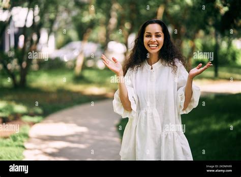 Admiring Curly Haired Brunette Girl With Raised Hands Stock Photo Alamy