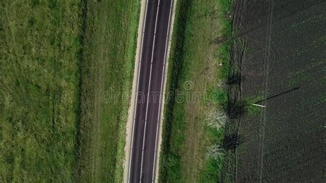 Aerial Top View Of Asphalting National Road Between Green Field And