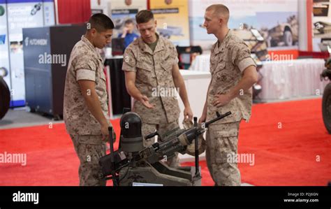 Marines Look At A Static Display Of A Modular Advanced Armed Robotics