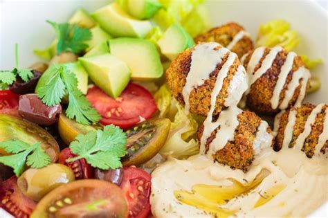 Premium Photo Falafel Plate With Salad Tomatoes Avocado Hummus And Olives