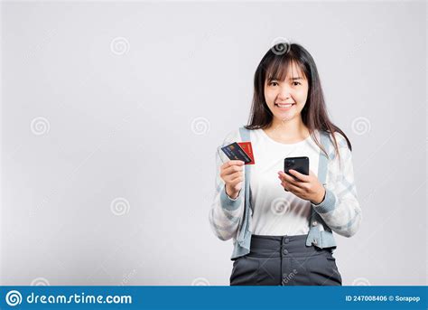 Woman Excited Smiling Hold Mobile Phone And Plastic Debit Credit Bank