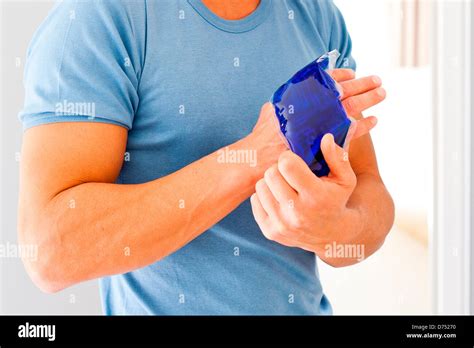Man Using A Hot Cold Gel Pack Treatment To Releive Pain Stock Photo Alamy