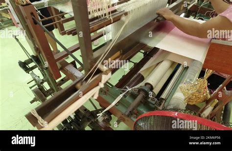 Weaving A Traditional Thai Dress On An Old Wooden Loom At The Jim