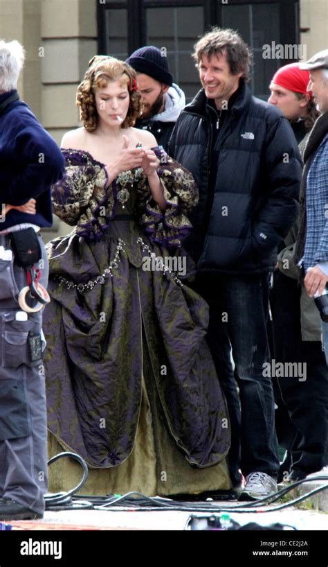 Milla Jovovich Lights Up A Cigarette On The Set Of The Three