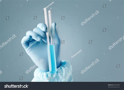 Hand Holding A Test Tube With Cyan Liquid Stock Photo