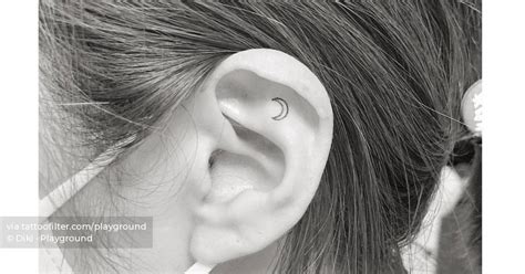 Micro Crescent Moon Tattoo Located On The Ear