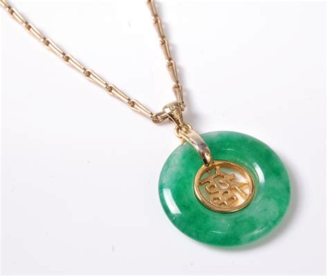 A Chinese Jade Pendant And 9ct Chain The Round Jade Pendant With