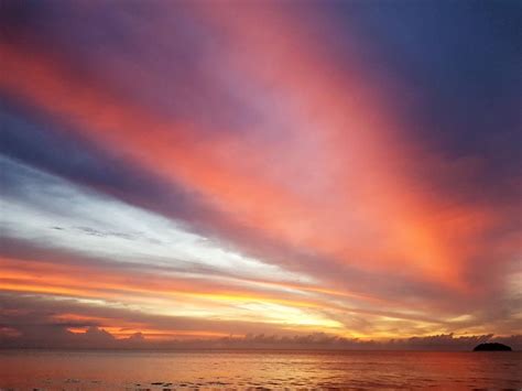 Rays Of Beautiful Sunset Light Reflected On Clouds And Sea Photograph