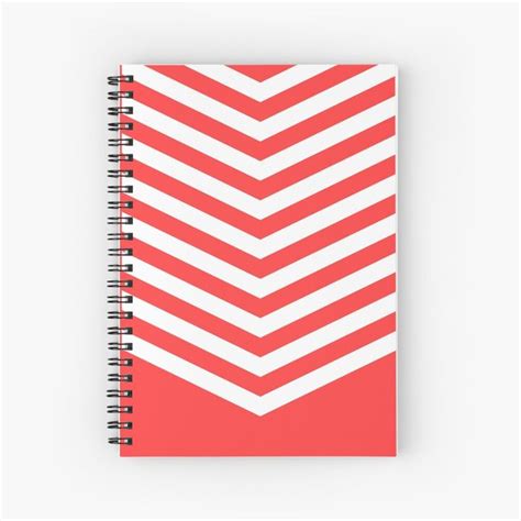 A Spiral Notebook With An Orange And White Zigzag Pattern