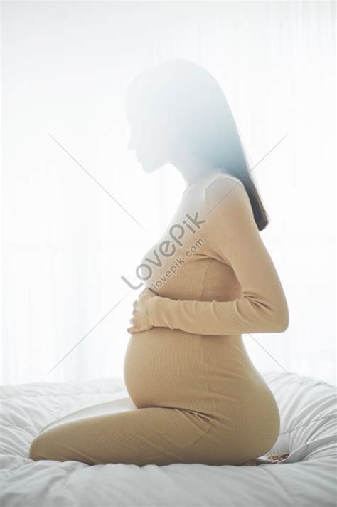 Stylish Photo Of An Elegant Pregnant Brunette Woman In A Beige Dress A Beautiful Representation