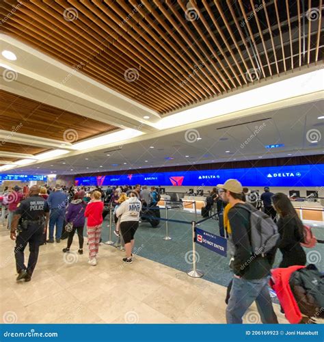 Blurred Passengers As they Walk by the Delta Ticket Counter at the