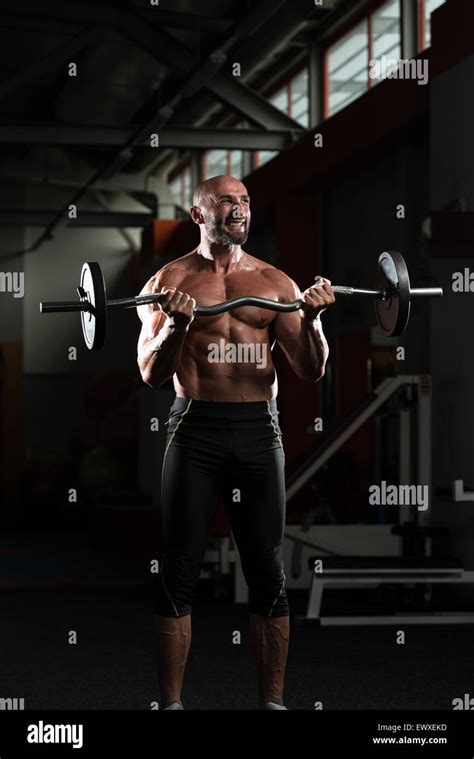 Mature Man Working Out Biceps In A Health Club Stock Photo Alamy