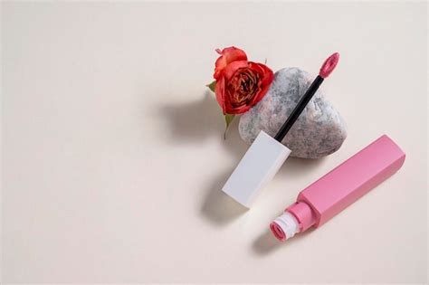 Premium Photo Pink Liquid Lipstick And Applicator Brush With Flowers