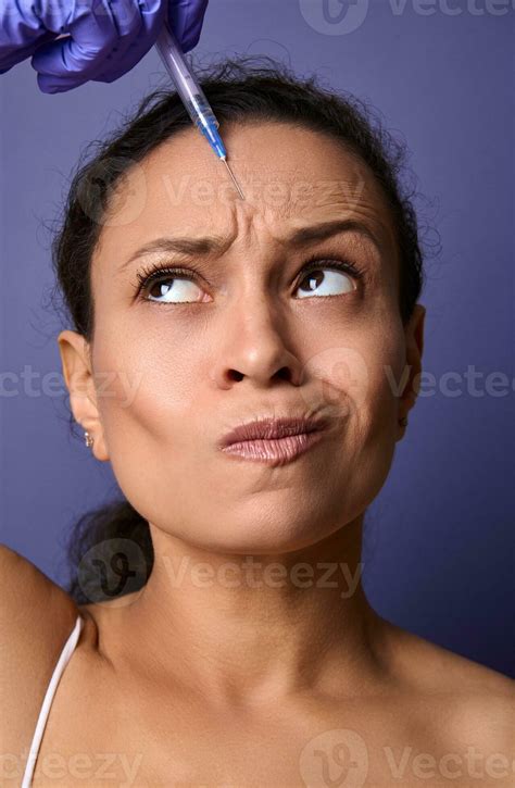 Beautiful Middle Aged Woman Receiving A Beauty Injection Of Botulinum Toxin Into Her Forehead