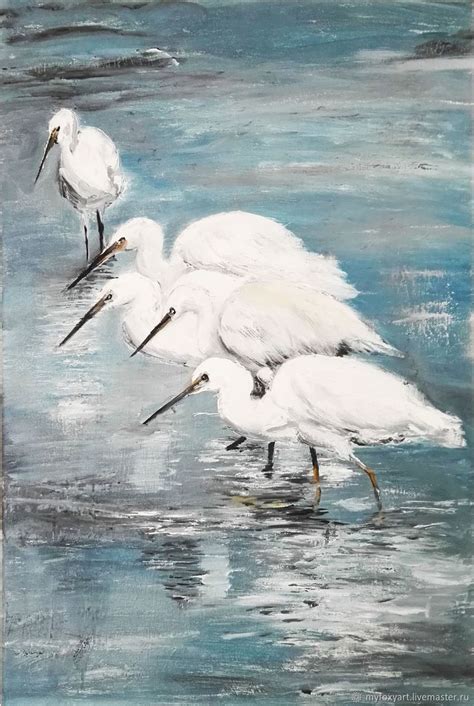 Three White Birds Are Standing In The Water