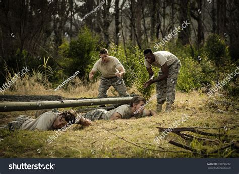 Soldiers Crawling Under Net During Obstacle Stock Photo 630990272