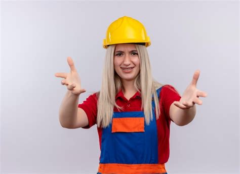 Souriante jeune fille blonde ingénieur constructeur en uniforme dans un appareil dentaire