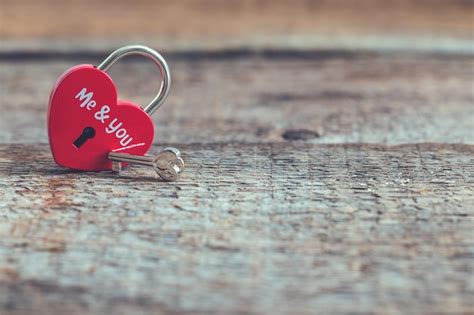 Premium Photo Red Heartshaped Padlock With Key On Wooden Background