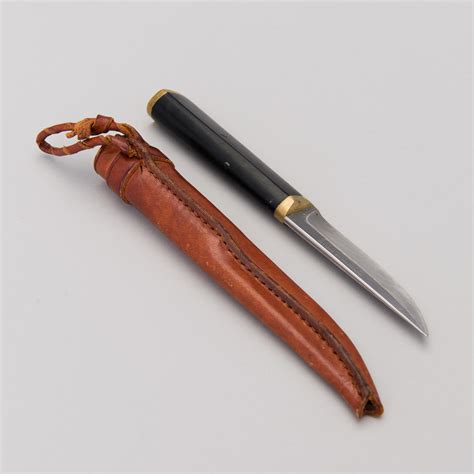 A Finnish Puukko Knife In Stainless Steel Nylon And Brass Designed By