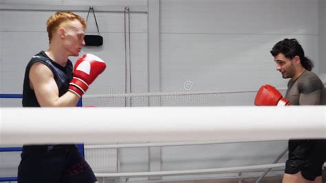 Two Boxers In Boxing Bandage Standing In Ready Pose On Boxing Ring