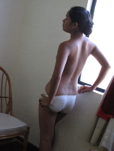 Barely Legal Asian Girl Casually Strips Off Her Clothes For Nude Poses