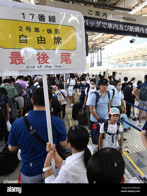 A Platform Of Shinkansen Bullet Train Is Crowded With Passengers With A