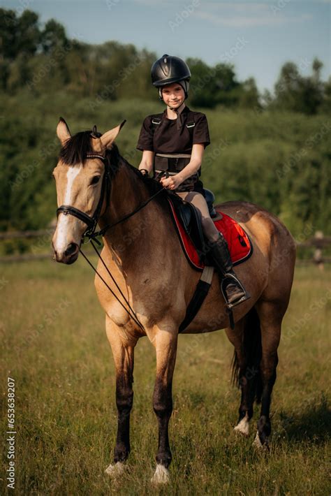 Portrait of a young jockey with a horse, horse riding training, a boy ...