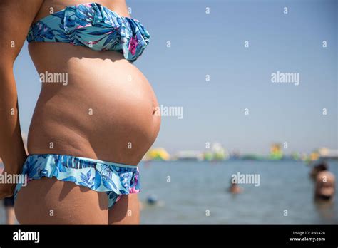 Close Up Of Pregnant Women Belly Wearing Colored Bikini On The Sea