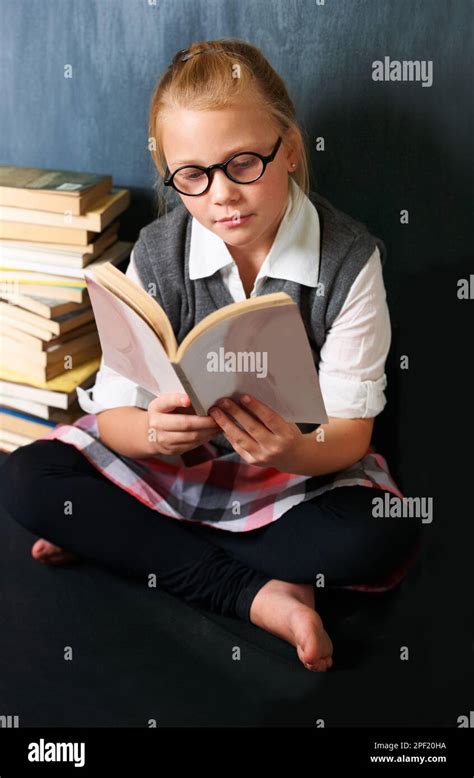 She Pefers To Stay In And Read During Breaktime A Cute Blonde Girl Reading Peacefully In Class