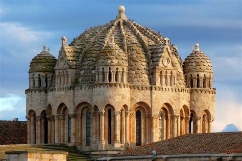 An Old Building With Many Spires On It S Roof And The Sky In The Background