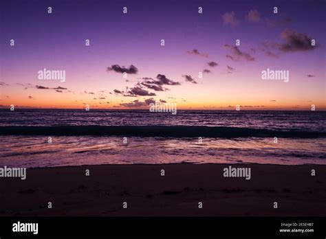 A calming purple sunrise on the beach Stock Photo - Alamy