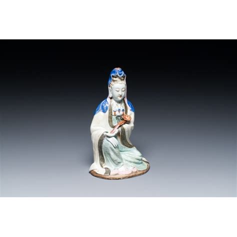 A Chinese Famille Rose Figure Of Guanyin With A Ruyi Scepter