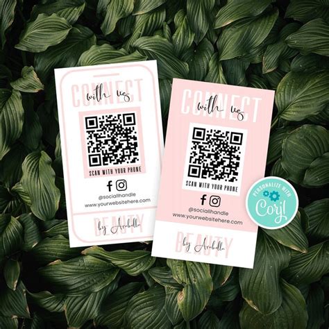 Two Cards With Qr Code On Them Sitting Next To Green Leaves In The