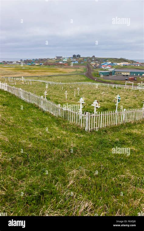 A Weathered Picket Fence Surrounds The Grave Crosses In The Cemetary