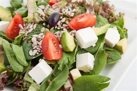 Spinach Salad With Avocado Feta Cheese Tomatoes And Seeds Stock Image