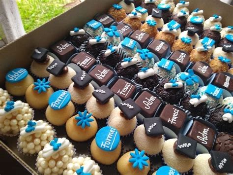 A Box Filled With Lots Of Cupcakes Sitting On Top Of A Table Next To