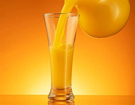 Premium Photo Orange Juice Pouring Into Glass With Splash