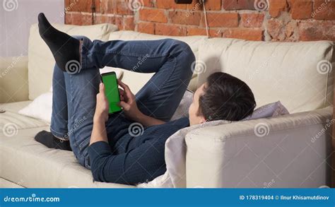 Man Holding A Smartphone In The Hands Of A Green Screen Green Screen