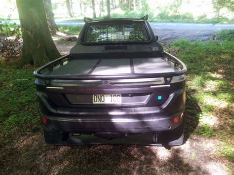 The Back End Of A Pickup Truck Parked In The Woods