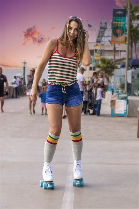 Lovely Brunette Female Model Rollerskates At The Beach Stock Image