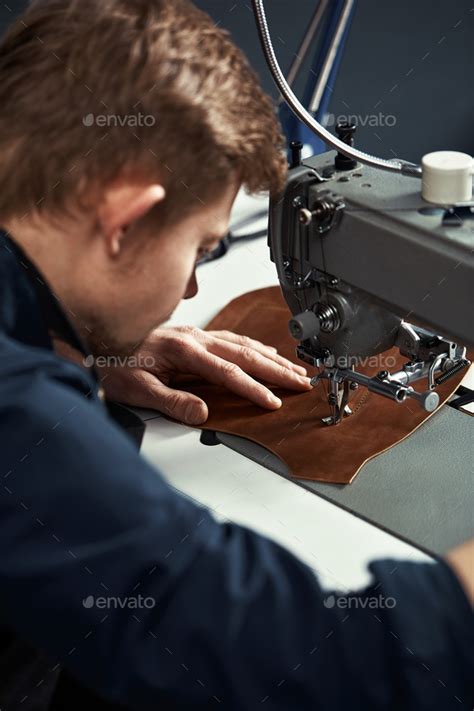 Working Process Of Leather Craftsman Tanner Or Skinner Sews Leather On